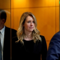 Former Theranos CEO Elizabeth Holmes leaves after a hearing at a federal court in San Jose, California, in July 2019. | REUTERS