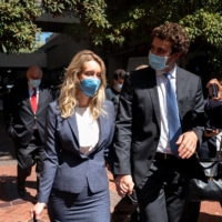 Elizabeth Holmes, the founder of the blood-testing startup Theranos, and her partner, Billy Evans, depart a federal courthouse after the first day of Holmes\'s trial in 2021. Evans was a consistent presence for Holmes at the trial. | MIKE KAI CHEN/THE NEW YORK TIMES