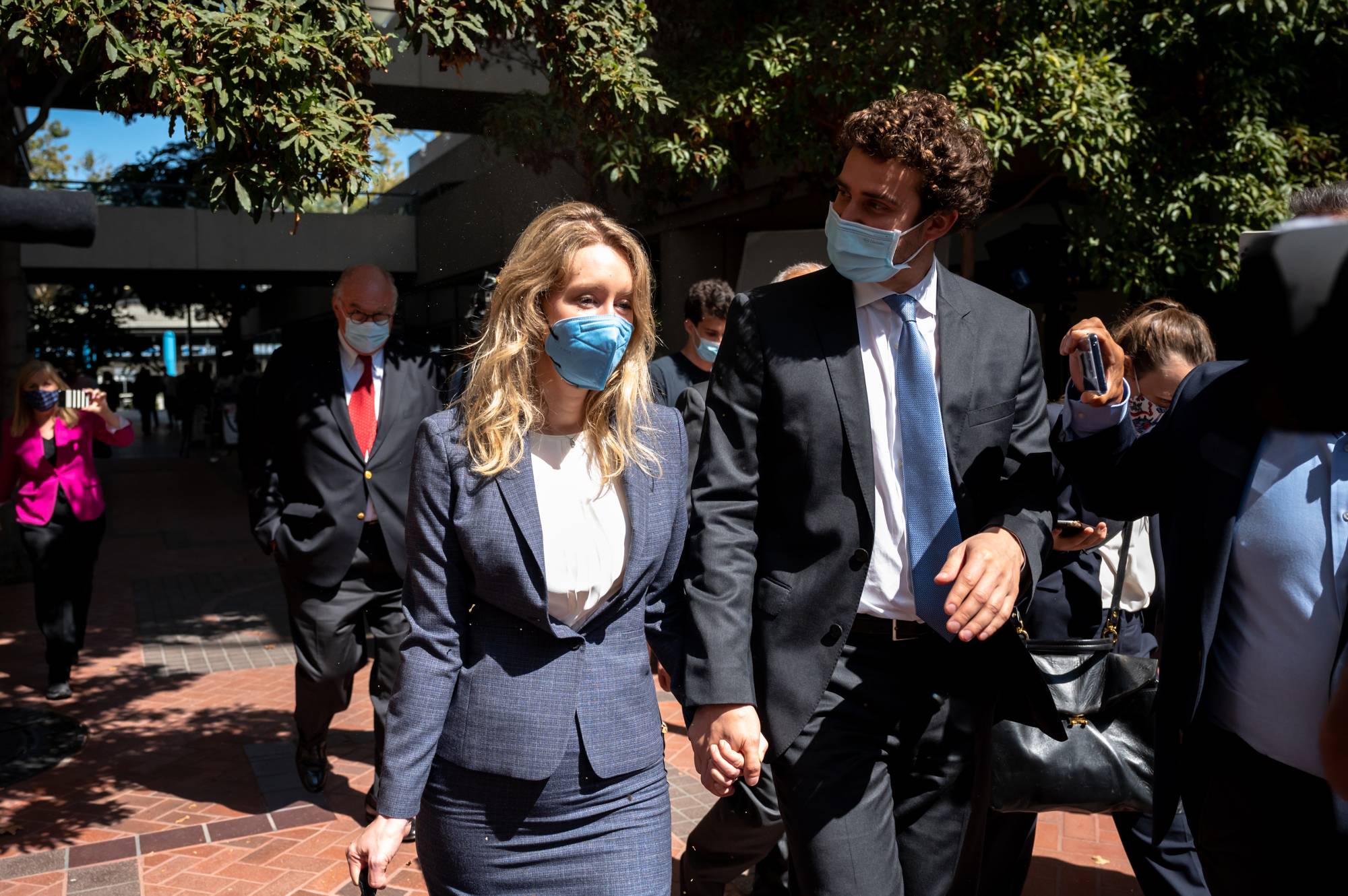 Elizabeth Holmes, the founder of the blood-testing startup Theranos, and her partner, Billy Evans, depart a federal courthouse after the first day of Holmes's trial in 2021. Evans was a consistent presence for Holmes at the trial. | Mike Kai Chen/The New York Times