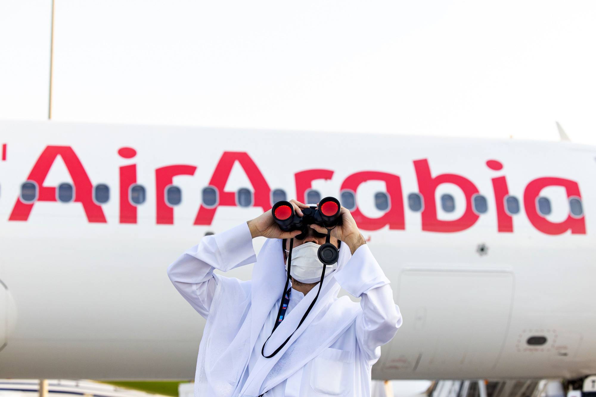An attendee watches an aircraft display at the 17th Dubai Air Show in November. | BLOOMBERG
