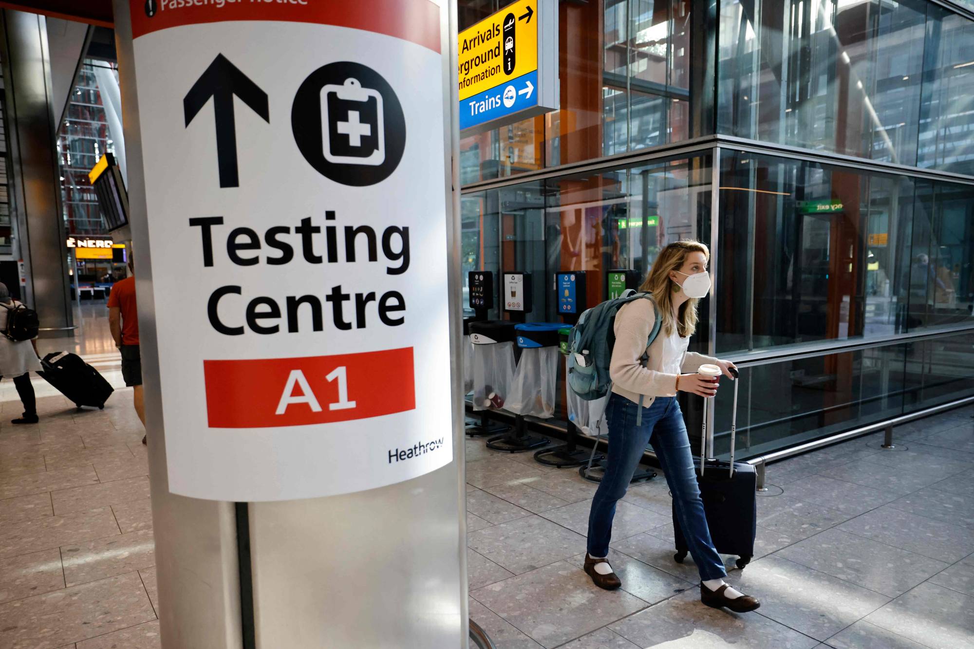 A COVID-19 testing center sign at Heathrow Terminal 5 in west London. The U.K. Health Security Agency says 100,000 more PCR booking slots per day have been made available since mid-December. | AFP-JIJI