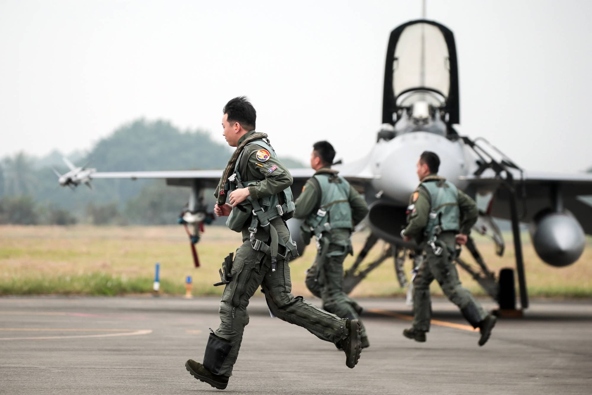 Taiwanese air force pilots during a military training exercise in Chiayi County, Taiwan, on Wednesday. Taiwan is bracing for more Chinese military patrols this year, after People's Liberation Army incursions more than doubled in 2021. | BLOOMBERG