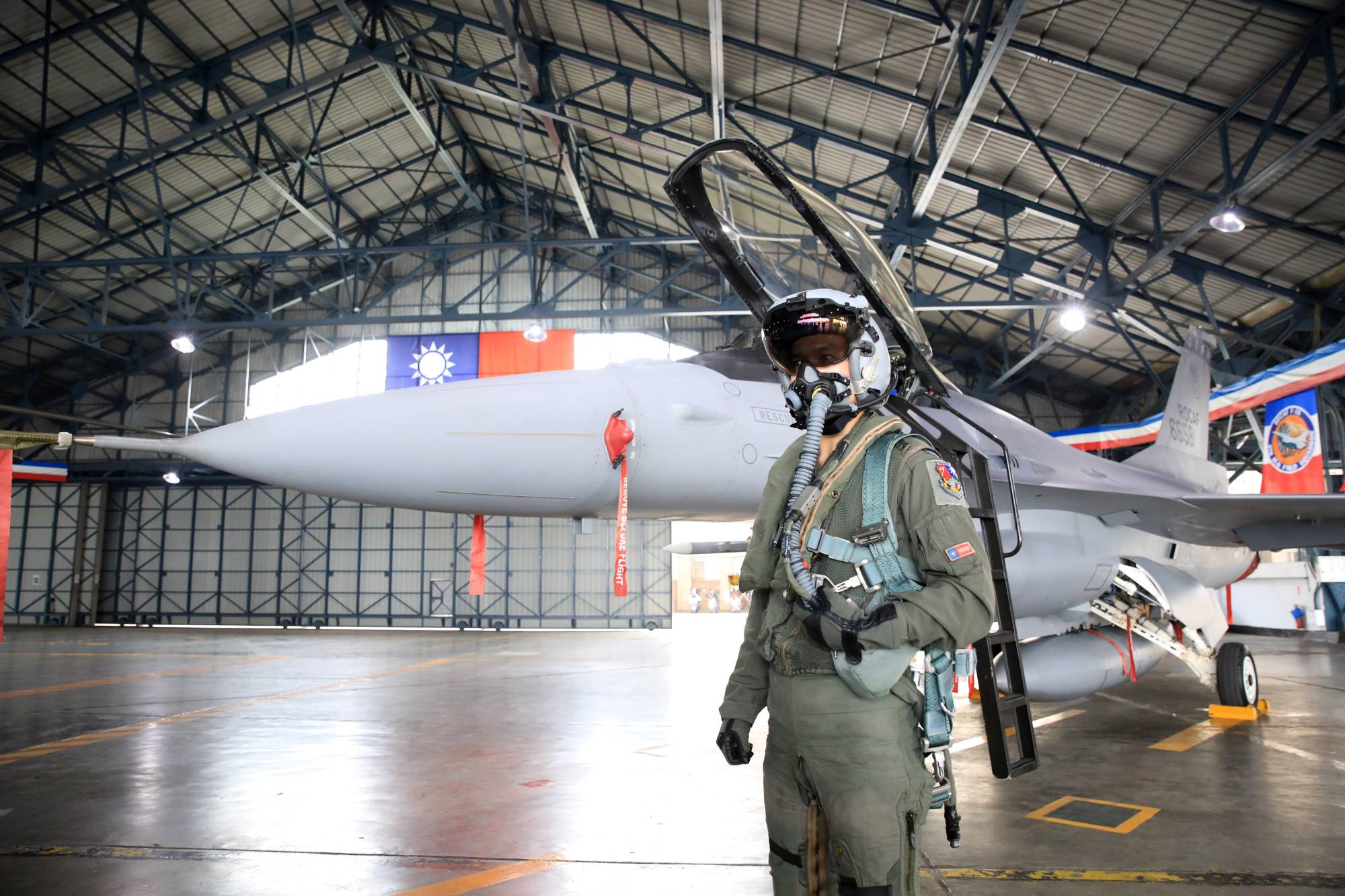 A Taiwanese air force pilot in front of a F-16V fighter jet during a military training exercise in Chiayi County, Taiwan, on Wednesday. | BLOOMBERG