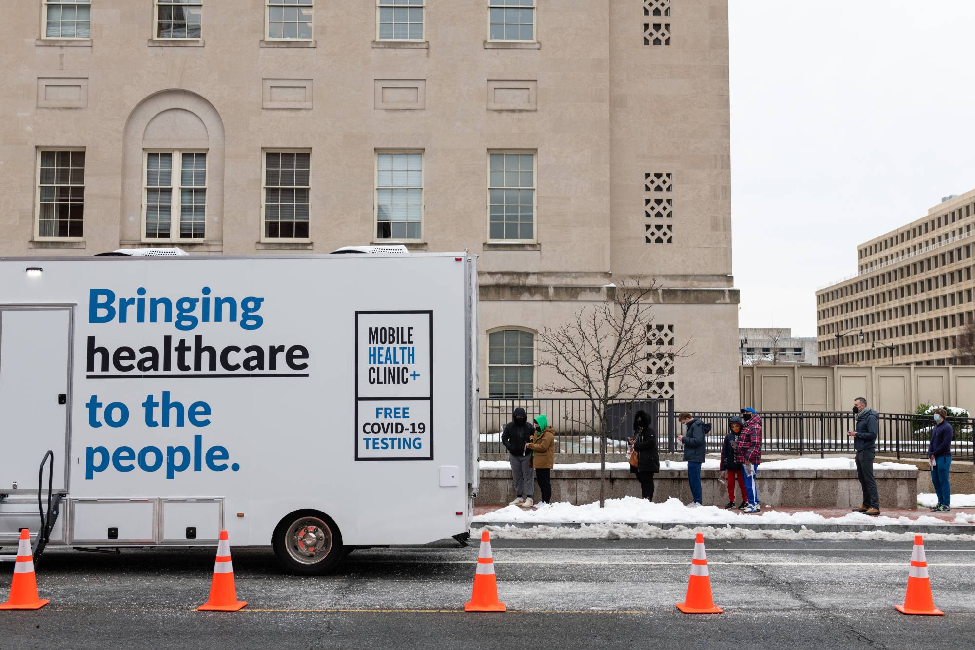 Residents stand in line to drop off COVID-19 PCR tests at a testing site run by the CDC, FEMA and eTrueNorth in Washington, D.C., on Wednesday. | Bloomberg