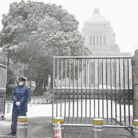 Snow falls on the Diet building in Tokyo on Thursday afternoon. | KYODO