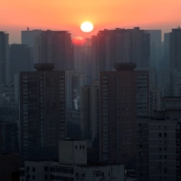 The sun rises in a neighborhood in Beijing on Thursday. | REUTERS
