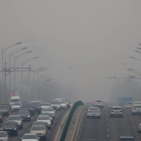 Smog over the Beijing in February 2021. China’s regulators have proposed cutting carbon allowances as the government seeks to raise the cost of pollution on its fledgling market for trading emissions. | REUTERS