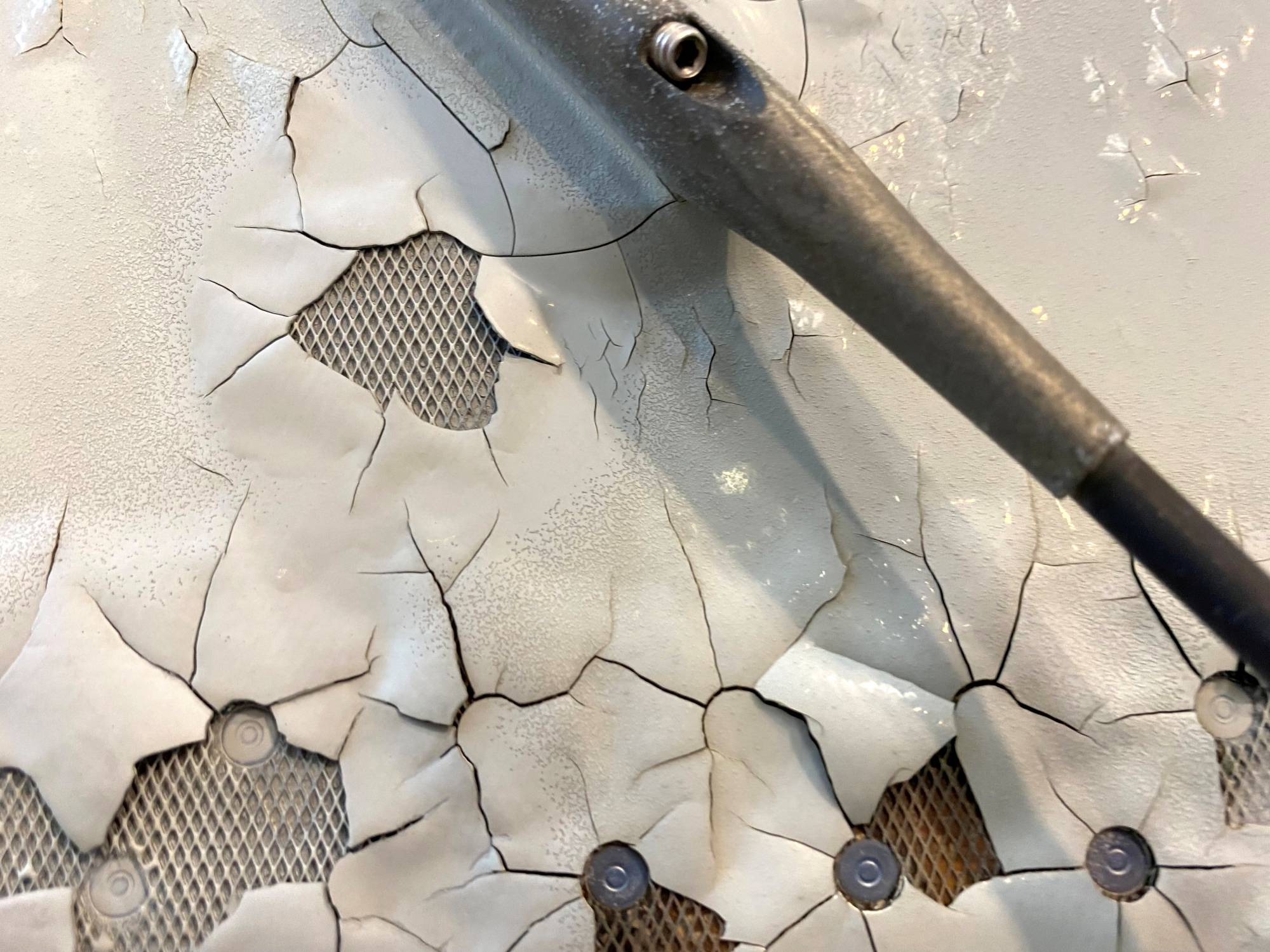 An image shows what appears to be paint peeling, cracking and exposed expanded copper foil (ECF) on the fuselage of a Qatar Airways A350 aircraft grounded by the Qatari regulator. | Reuters