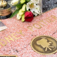 People place flowers on Sidney Poitier\'s star on the Hollywood Walk of Fame in Hollywood, California, on Friday. | AFP-JIJI