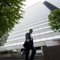 A pedestrian walks past the Public Prosecutors Office in Tokyo. Japanese prosecutors have remotely questioned people in connection with criminal cases in order to prevent coronavirus infection, according to sources familiar with the matter. | BLOOMBERG