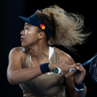 Naomi Osaka hits a return during her match against Andrea Petkovic on Friday in Melbourne.  | AFP-JIJI