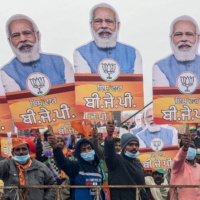 Bharatiya Janata Party supporters hold cut-outs with portraits of Prime Minister Narendra Modi during a rally Wednesday in Ferozepur, India. | AFP-JIJI