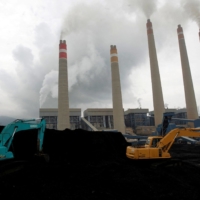 Excavators pile coal in a storage area at an Indonesia Power plant in Suralaya, Banten province. | REUTERS 