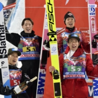 The Japanese team celebrates on the podium after finishing second in a World Cup event in BISCHOFSHOFEN, Austria, on Sunday. | KYODO