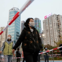 People queue up at a makeshift community testing center for COVID-19 in Hong Kong on Jan. 9. | REUTERS