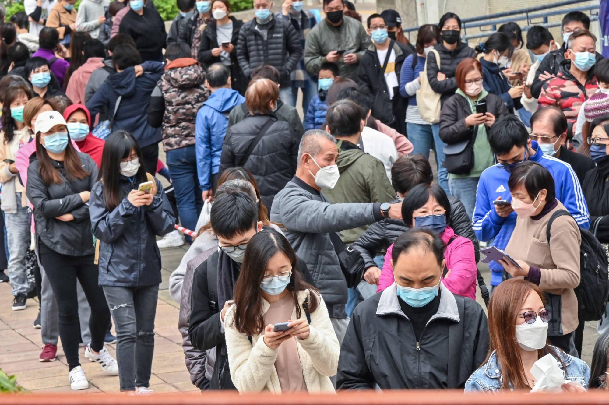 People line up for COVID-19 tests in Hong Kong on Wednesday.  | AFP-JIJI
