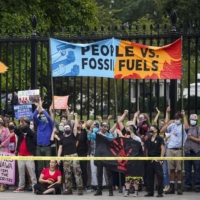 Demonstrators gather during a climate change protest on Indigenous Peoples\' Day outside the White House in Washington in October.  | BLOOMBERG
