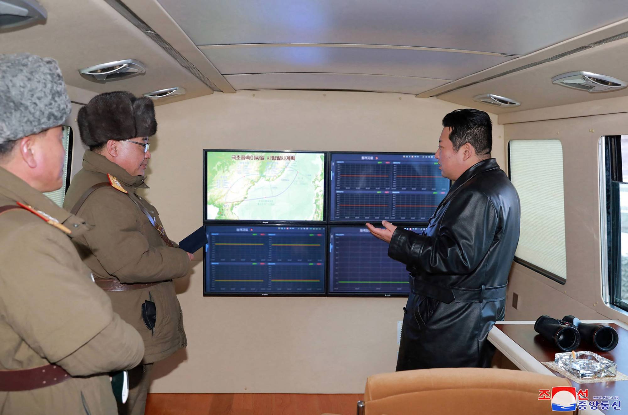 North Korean leader Kim Jong Un speaks with military officials during an observation of a missile test on Tuesday.  | KCNA / KNS / VIA AFP-JIJI