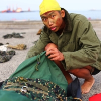 Liu Zi-Xian, 25, prepares to change into running clothes after a long swim as part of training for Taiwan\'s elite Amphibious Reconnaissance and Patrol unit.  | REUTERS