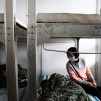 Liu Zi-Xian is comforted by his mother while resting in his bunk, at Zuoying navy base in Kaohsiung, Taiwan.  | REUTERS