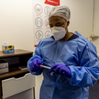 A health worker prepares a coronavirus swab test at a Testaro COVID-19 testing site in the Goodwood district of Cape Town, South Africa, on Thursday, Dec. 2, 2021.  | BLOOMBERG
