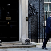 British Prime Minister Boris Johnson walks outside No. 10 Downing Street in London on Wednesday.  | REUTERS