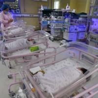 A medical worker cares for a newborn baby in the pediatric ward of a hospital in China\'s eastern Anhui province. The birthrate in China plummeted to a record low last year, official data showed on Jan. 17, with analysts warning of a faster-than-expected pace of aging and as concerns mount over future growth. | AFP-JIJI
