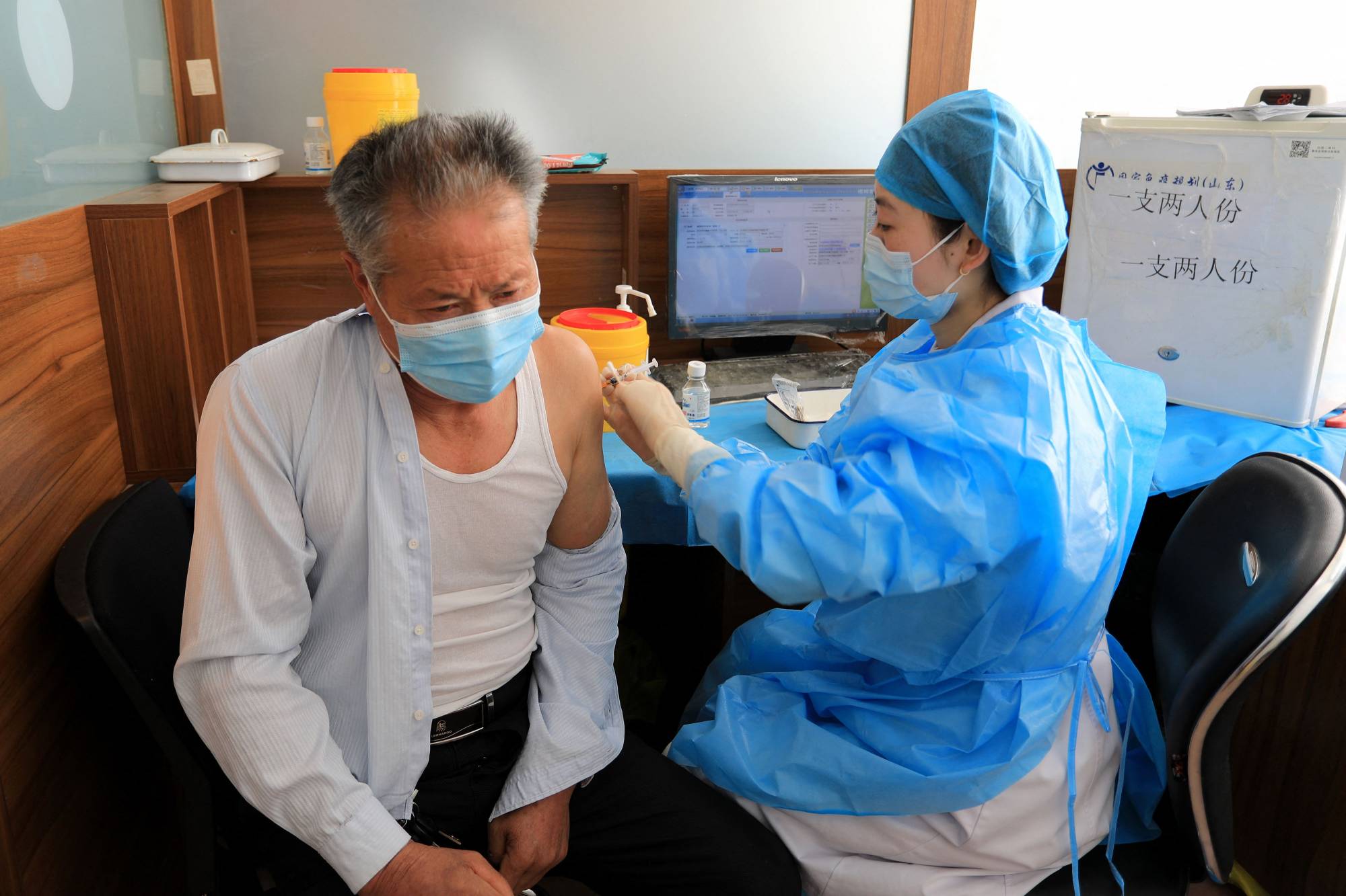 A resident receives a booster shot of the Sinovac COVID-19 vaccine in Rongcheng, in China's eastern Shandong province, on Jan. 9. | AFP-Jiji