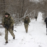 Ukrainian border guards on a joint patrol near the border with Belarus on Jan. 9. | TYLER HICKS / THE NEW YORK TIMES