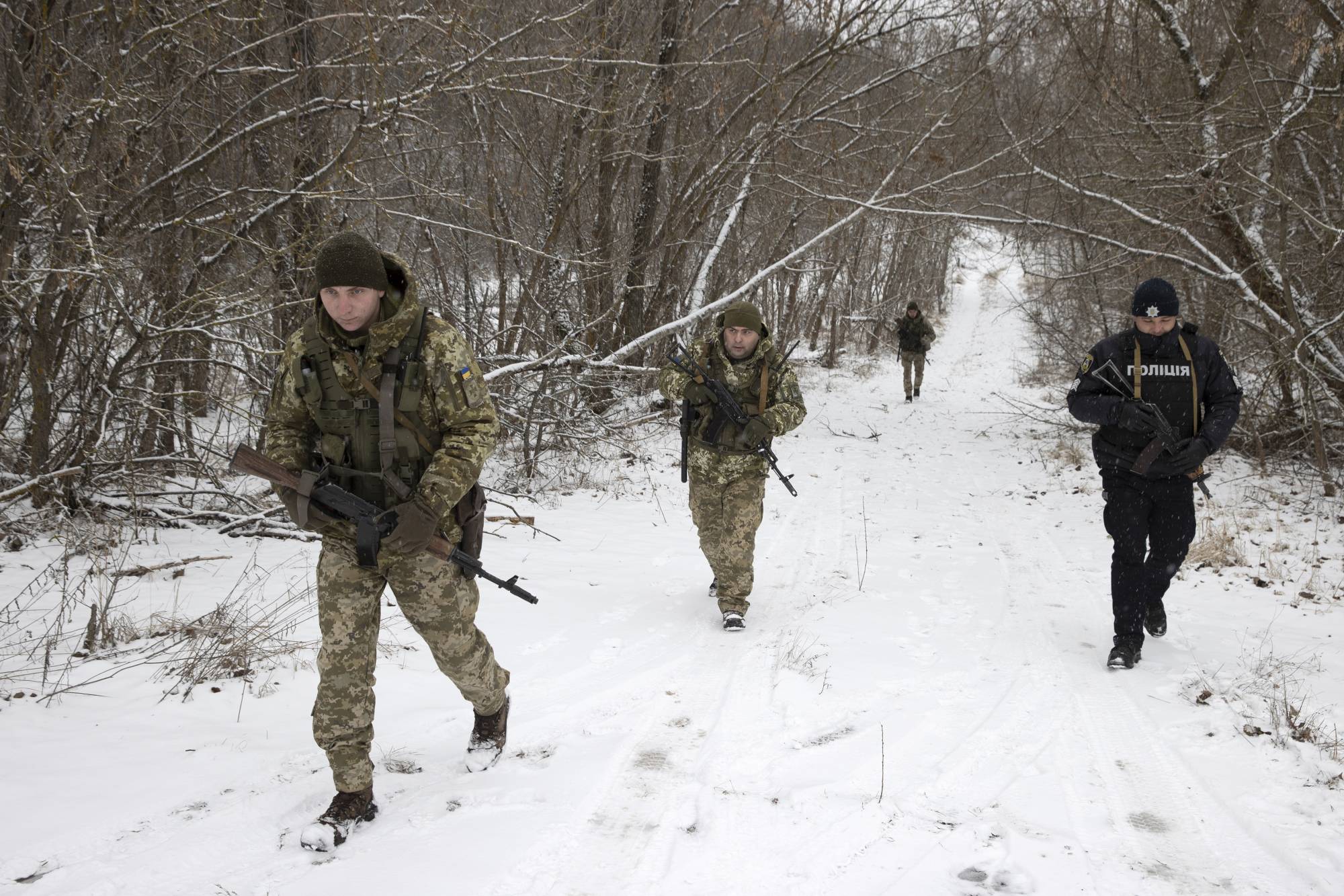Ukrainian border guards on a joint patrol near the border with Belarus on Jan. 9. | TYLER HICKS / THE NEW YORK TIMES