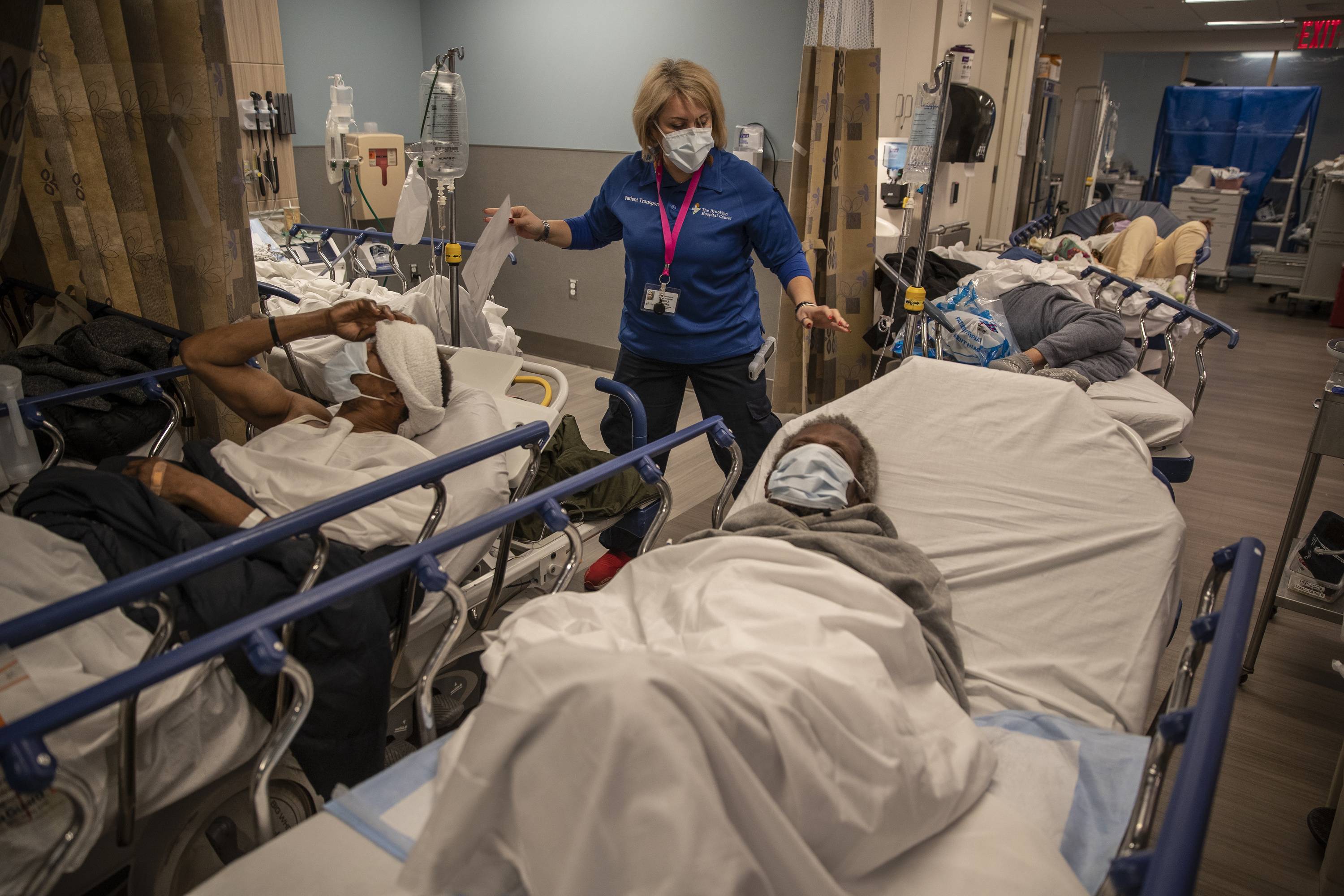 COVID-19 patients lie side by side on stretchers at the short-staffed Brooklyn Hospital Center in New York on Jan. 12. | VICTOR J. BLUE / THE NEW YORK TIMES