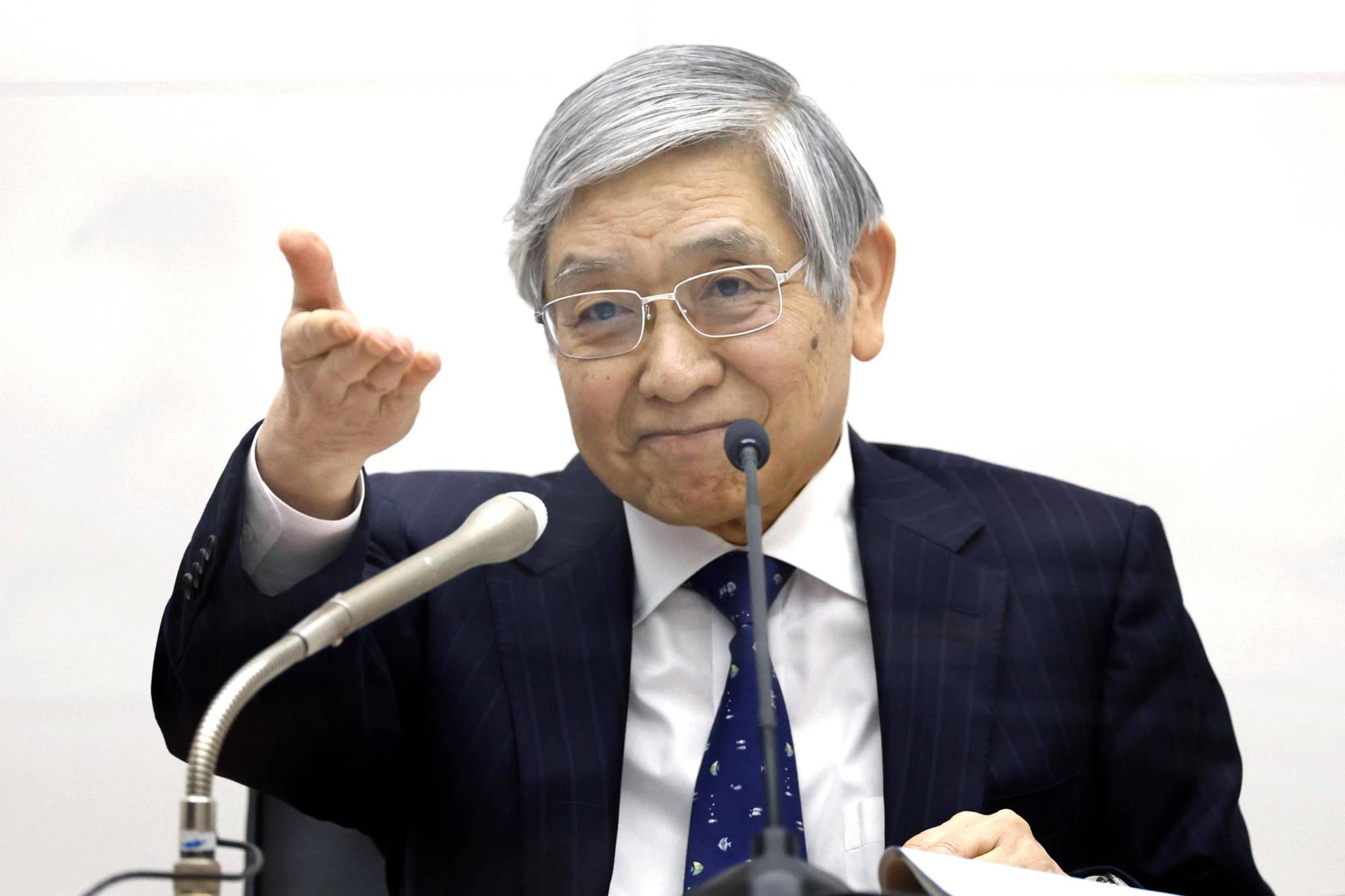 Bank of Japan Gov. Haruhiko Kuroda gestures during a news conference in Tokyo on Tuesday. | Bloomberg 