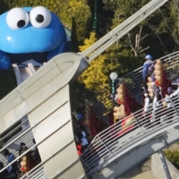 People stranded on a roller coaster at Universal Studios Japan in Osaka are rescued by staff members on Saturday afternoon.  | KYODO 