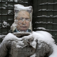 A poster of Russian President Vladimir Putin is used as target practice along a trench on the frontline with Russia-backed separatists near Zolote village, in the Lugansk region, on January 21, 2022.  | AFP-JIJI