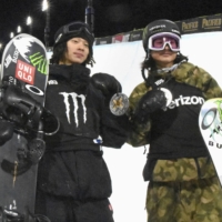 Ayumu (left) and Kaishu (right) Hirano pose with their second- and third-place medals after the snowboard halfpipe competition at the X Games in Aspen, Colorado, on Saturday. | KYODO