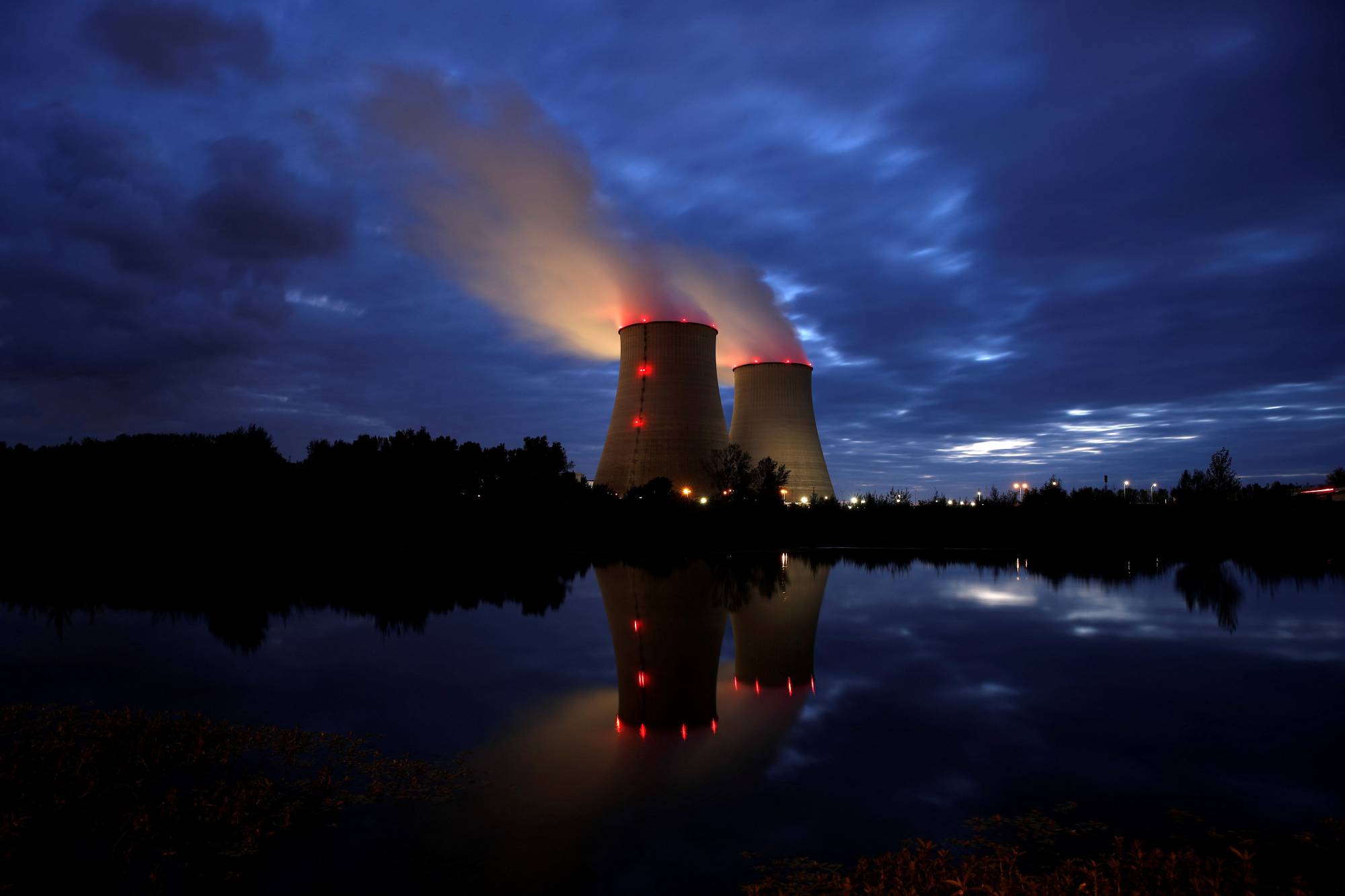 Steam rises from cooling towers of the Electricite de France (EDF) nuclear power plant in Belleville-sur-Loire, France, on Oct. 12. | REUTERS