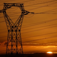 A pylon carrying high-tension electricity power lines stands against the sunset near Nantes, France, on Thursday. | REUTERS
