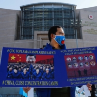 An ethnic Uyghur takes part in a protest against China in Istanbul on Jan. 4.   | REUTERS