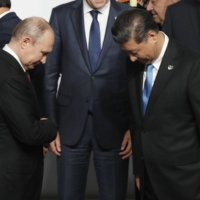 Vladimir Putin and Xi Jinping attend a family photo session at the G20 summit in Osaka in June, 2019. | BLOOMBERG
