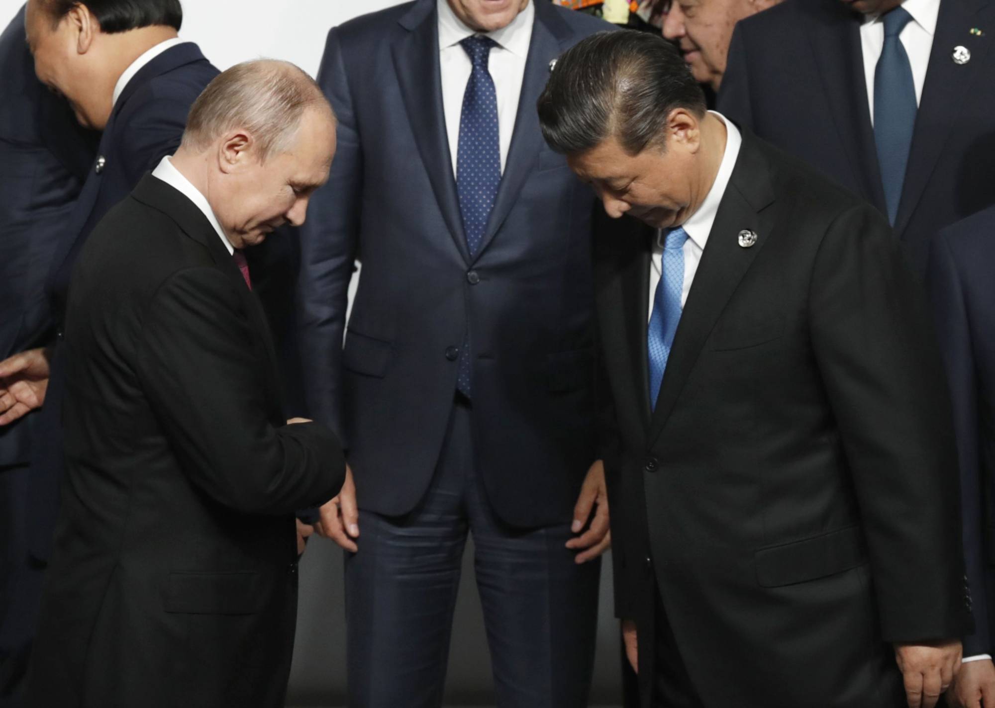Vladimir Putin and Xi Jinping attend a family photo session at the G20 summit in Osaka in June, 2019. | Bloomberg 