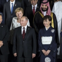 From left to right, Canadian Prime Minister Justin Trudeau, Chinese President Xi Jinping, former German Chancellor Angela Merkel, Russian President,Vladimir Putin, Saudi Arabia\'s Crown Prince Mohammed Bin Salman, Akie Abe, wife of Japan\'s former Prime Minister Shinzo Abe, and Shinzo Abe, along with other world leaders and delegates posing for a family photograph at the G20 summit in Osaka in June, 2019.  | BLOOMBERG