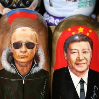 Matryoshka dolls depicting Russian President Vladimir Putin Chinese President Xi Jinping on display at a stall ahead of the St. Petersburg International Economic Forum (SPIEF) in St. Petersburg, in June, 2019.  | BLOOMBERG