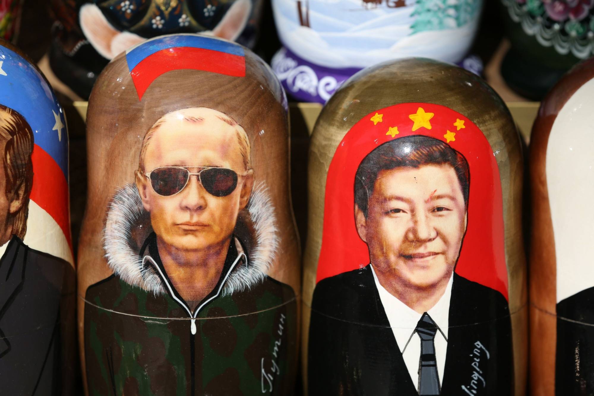 Matryoshka dolls depicting Russian President Vladimir Putin Chinese President Xi Jinping on display at a stall ahead of the St. Petersburg International Economic Forum (SPIEF) in St. Petersburg, in June, 2019.  | BLOOMBERG