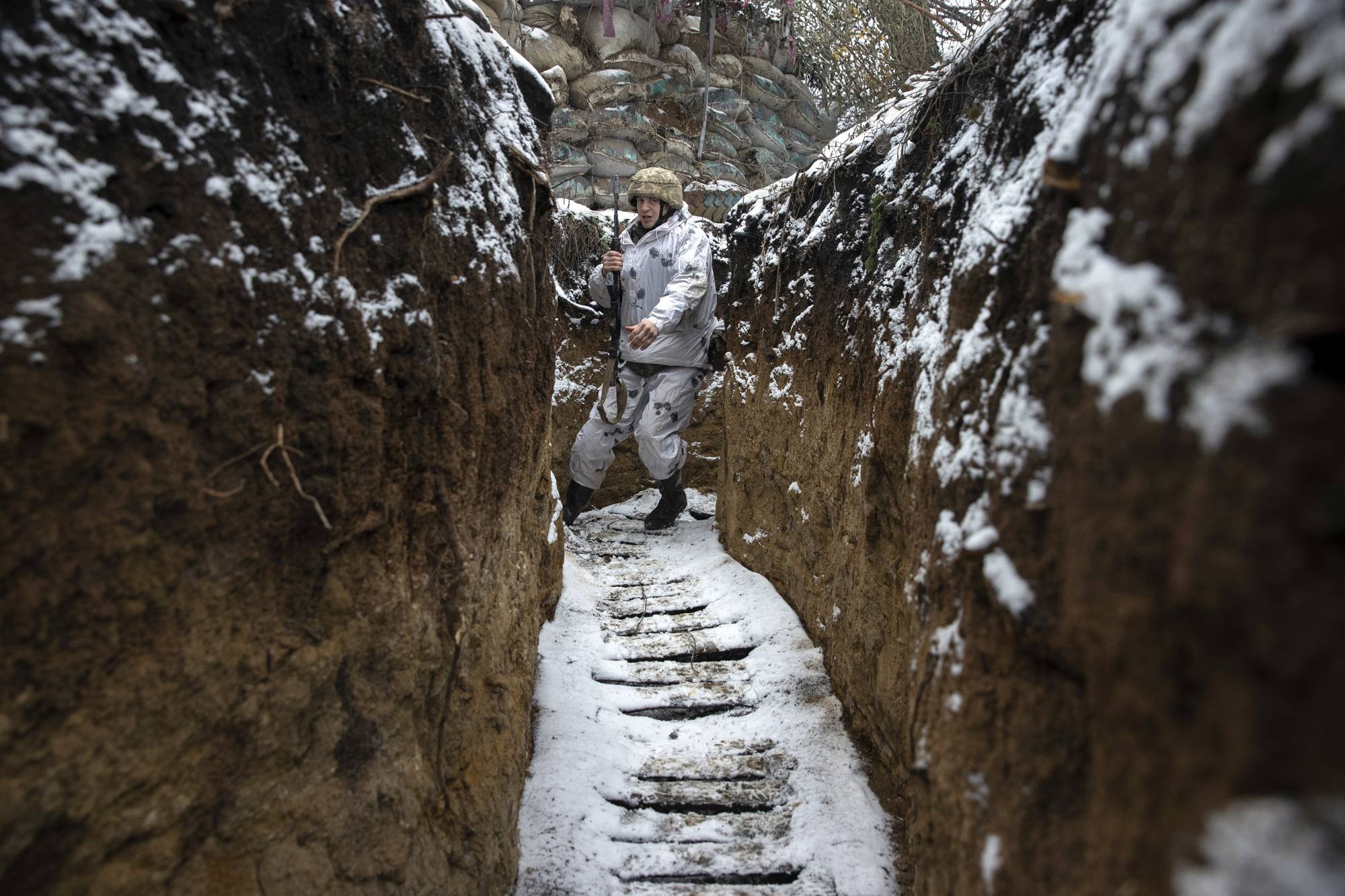 A member of the Ukrainian military in a front-line trench in the Luhansk Oblast province of eastern Ukraine on Tuesday.  | TYLER HICKS / THE NEW YORK TIMES