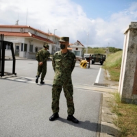 Ground Self-Defense Force soldiers stand guard at the entrance gate of their base in Yonaguni Island, the country\'s westernmost inhabited islet, in Okinawa Prefecture, last October. | REUTERS