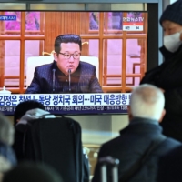 People watch a news broadcast with footage of North Korean leader Kim Jong Un, at a railway station in Seoul on Thursday, after North Korea hinted at resuming weapons tests as it prepared for \"long-term confrontation\" with the United States.  | AFP-JIJI