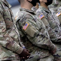 Soldiers wait to greet U.S. President Joe Biden at Fort Bragg in North Carolina on Nov. 22. Defense Secretary Lloyd Austin has put 8,500 American troops on high alert for possible deployment to Eastern Europe. | STEFANI REYNOLDS / THE NEW YORK TIMES