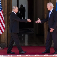 U.S. President Joe Biden and Russian President Vladimir Putin greet one another during a summit in Geneva, Switzerland, in June. | DOUG MILLS / THE NEW YORK TIMES