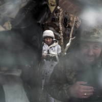 Ukrainian soldiers are seen in a bunker on the front line in Popasna, Ukraine, on Monday. | BRENDAN HOFFMAN/THE NEW YORK TIMES
