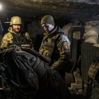 Ukrainian soldiers inside a bunker near the front line in Popasna, Ukraine, on Monday | BRENDAN HOFFMAN / THE NEW YORK TIMES